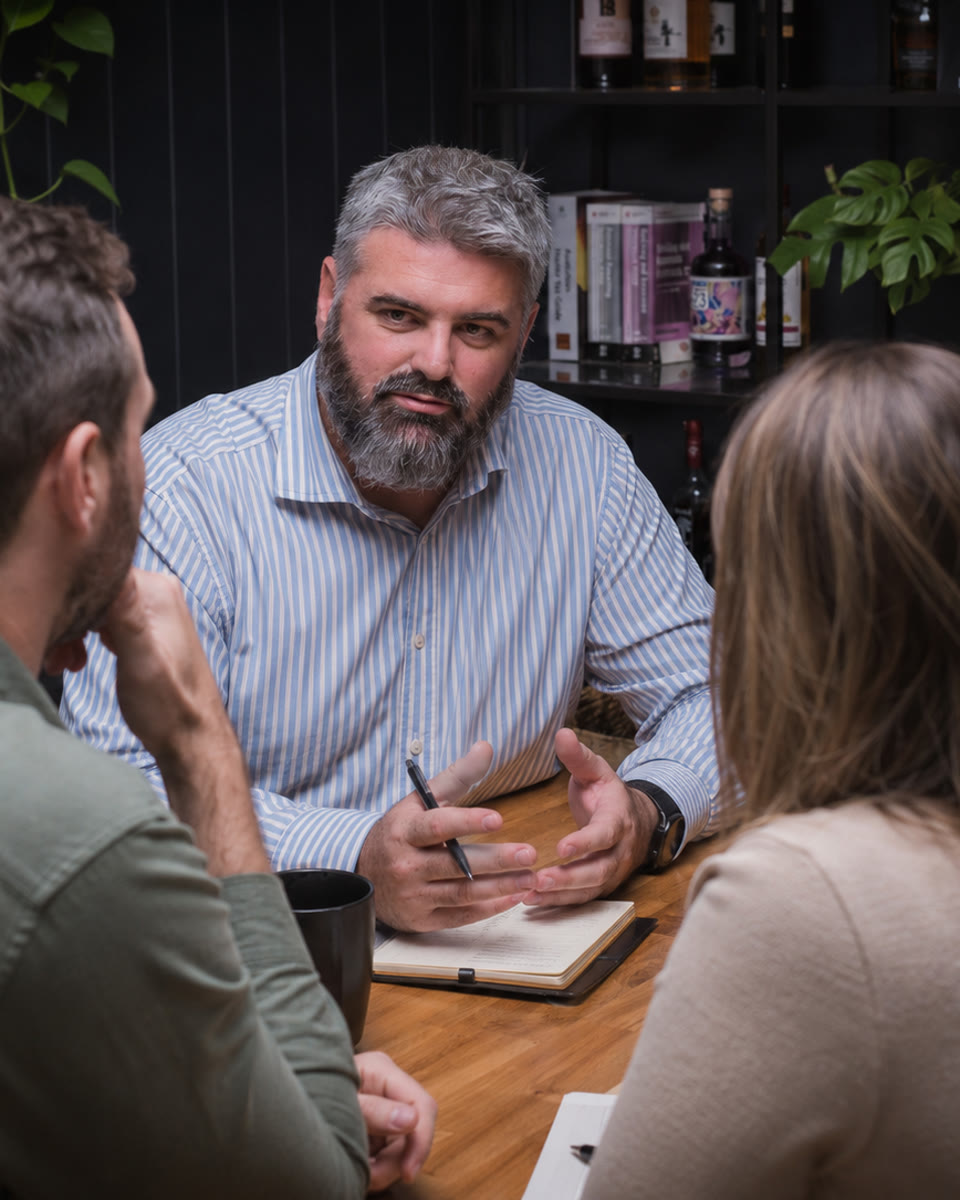 Cameron Whinnett in a working session with business owners at a table